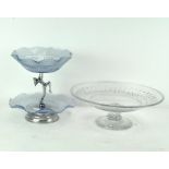 A glass two-tier cake stand with fluted rims, supported with a female figure to the centre,