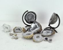 Assorted quartz geodes and stones, including two halves of a globe-shaped geode,