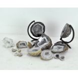 Assorted quartz geodes and stones, including two halves of a globe-shaped geode,