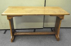 An early 20th century oak arts and crafts dining table of rectangular form,