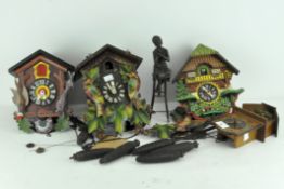 A collection of three Black Forest style cuckoo clocks, with chains,