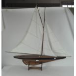 A Nauticalia wooden model of a sailing boat, on stand, bearing metal plaque,