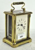 A 20th century brass cased carriage clock by Dominion, made in England,