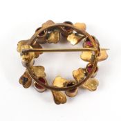 A gold plated wreath brooch set with simulated pearls and synthetic cabochons. Pin and hook.