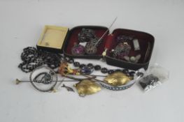 A quantity of costume jewellery to include a large Scottish brooch, necklaces,