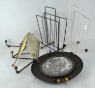 A collection of mid-century retro magazine racks, a coat hook,