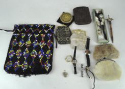 A collection of ladies accessories including fabric and fur purses, assorted watches and hatpins,