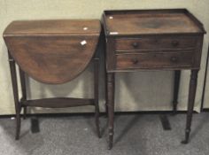 A mahogany drop leaf table with inlaid details, on splayed supports,