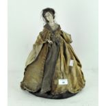 A vintage tea cosy, modelled as a woman in 18th century style velvet gown,