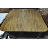 A Victorian mahogany dining table and two leaves,