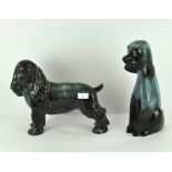 Two large pottery models of dogs, 20th century, each glazed in graduated turquoise hues,