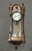 A Vienna-style regulator clock, 31 day, with white enamel dial and Roman numerals,