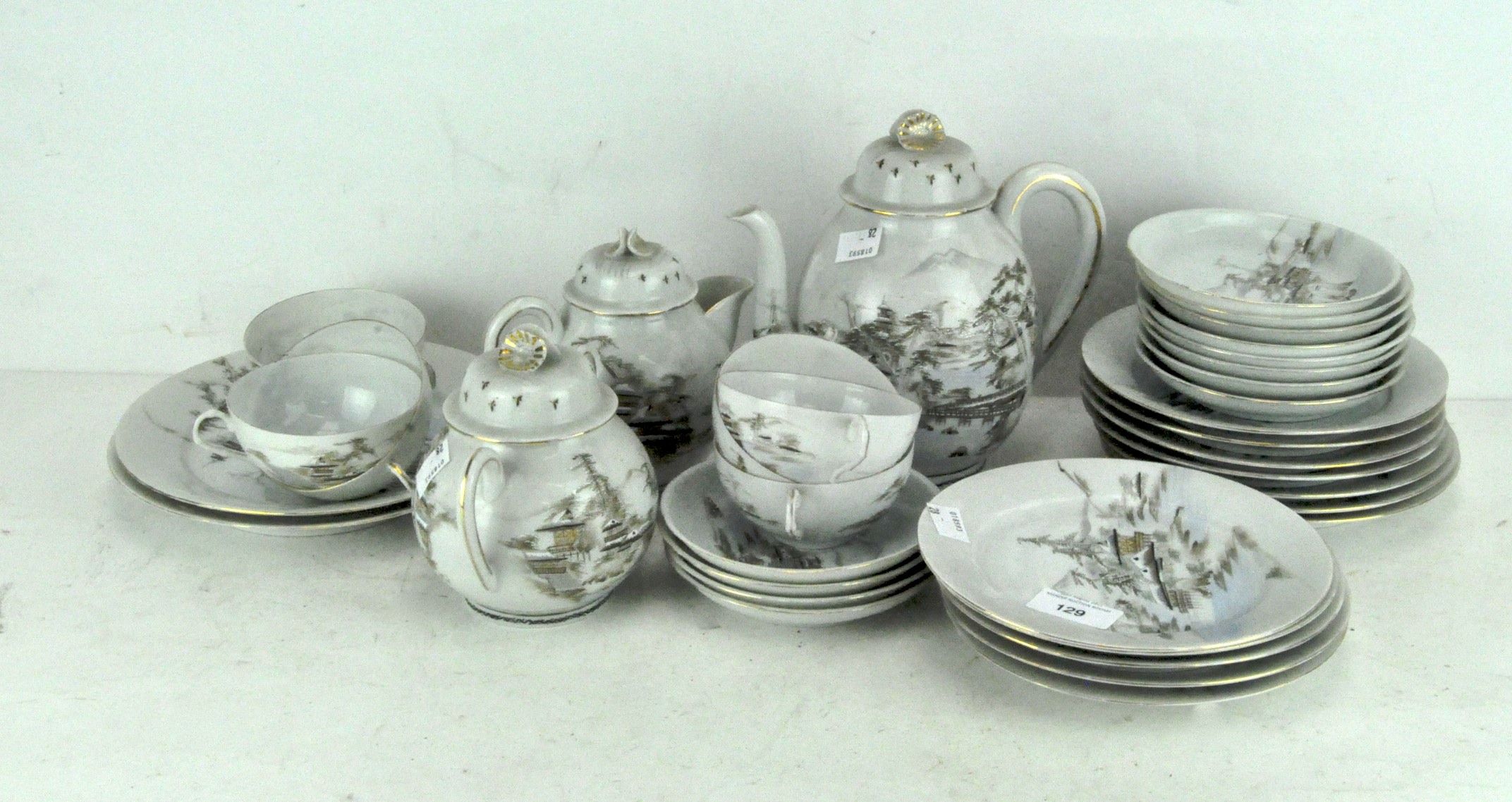 An early 20th century Japanese eggshell porcelain part tea set,