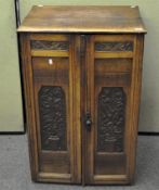 An early 20th century oak Maple & Co London cabinet,