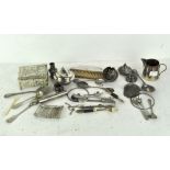 A group of silver plated wares, including sugar tongs, mesh purse,