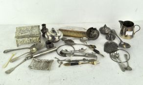 A group of silver plated wares, including sugar tongs, mesh purse,