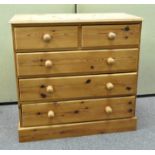 A 20th century pine chest of drawers with two over three drawers,