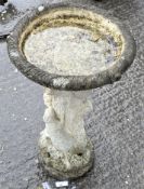 A composite stone bird bath on pedestal