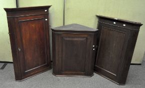 Three Edwardian mahogany corner cabinets with cut corners,