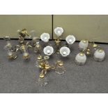 Four brass and gilt metal chandeliers, with glass shades,