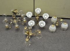 Four brass and gilt metal chandeliers, with glass shades,