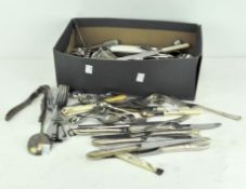A collection of vintage silver plated and stainless steel flatware, tongs and other items