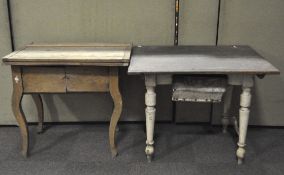 A vintage Hungarian kitchen table with a low drawer and white painted turned legs,