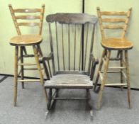 A 20th century spindle back rocking chair together with two ladderback high chairs/bar stools