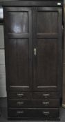 A Victorian oak linen cupboard with small drawers and shelves behind double doors over four drawers,