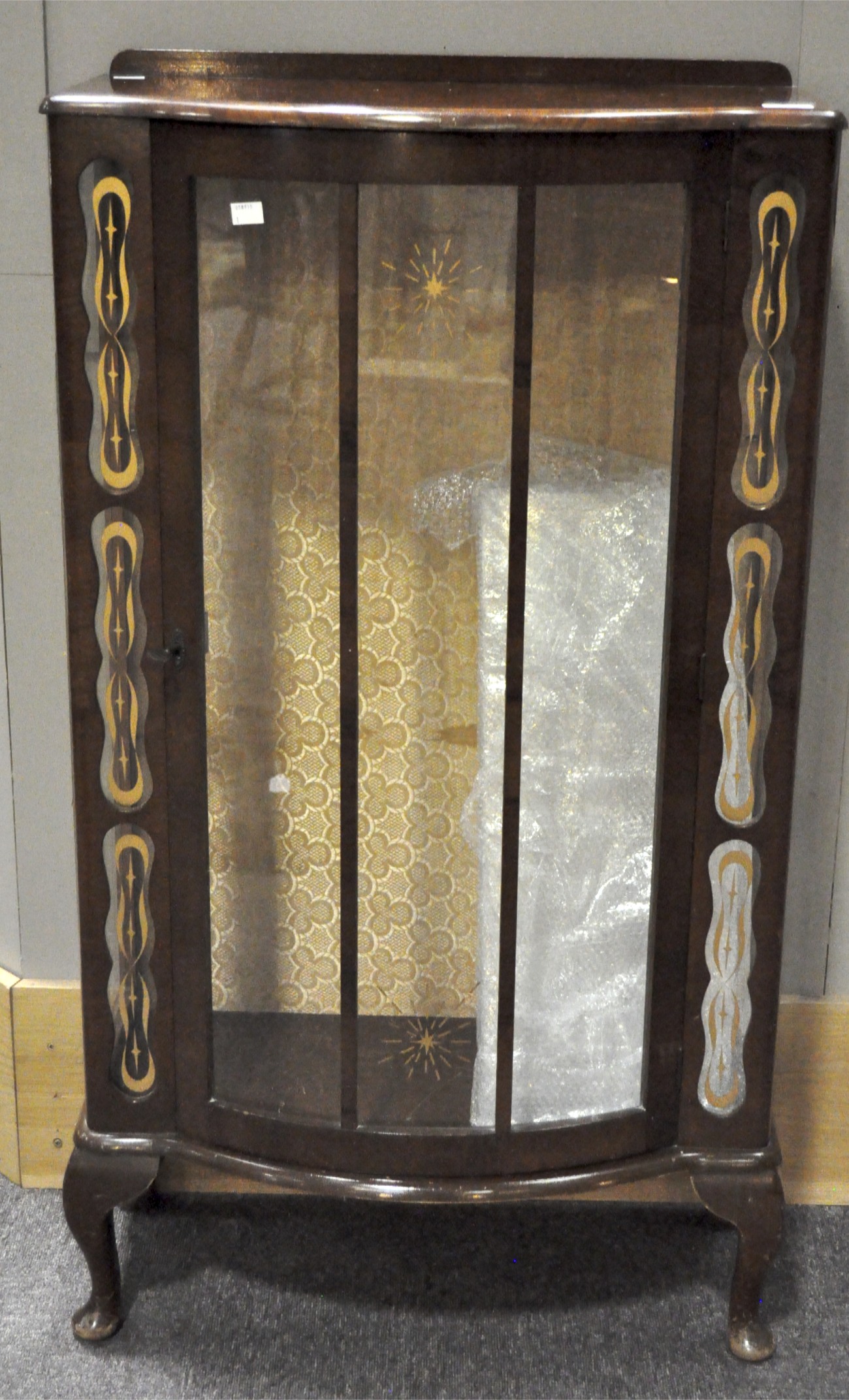 Art Deco glazed display cabinet, of curved outline.