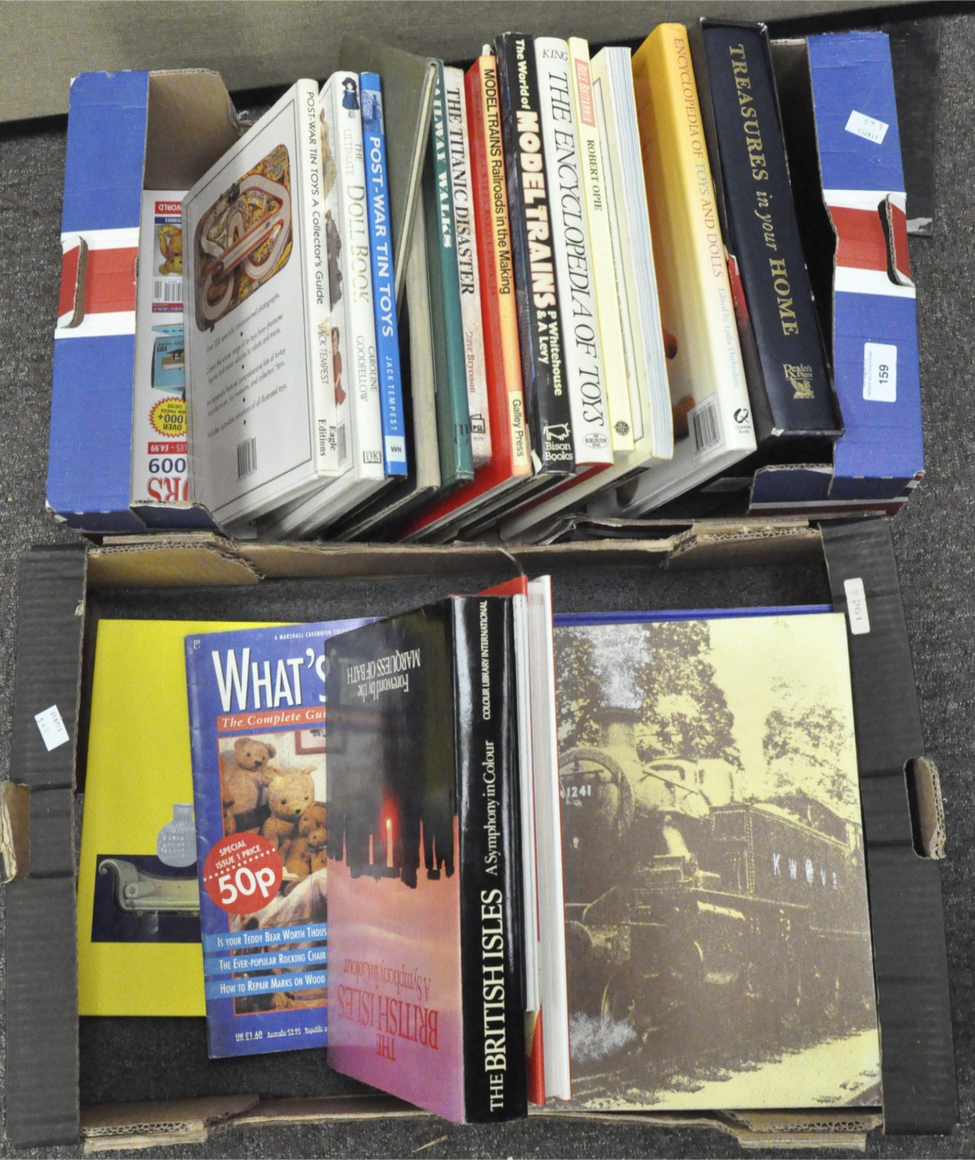 An assortment of antiques and toy reference books including Reader's Digest
