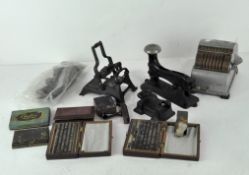 A collection of vintage stationery equipment, including a printing press, blocks,