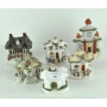 A group of five Staffordshire pottery sprigged pastille burners, modelled as houses and cottages,