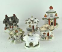 A group of five Staffordshire pottery sprigged pastille burners, modelled as houses and cottages,