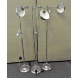 Three modern chrome standard lamps with swivel head and bowl shades on a round foot,