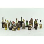 A collection of miniature bottles of spirits and alcohol, comprising Port, Whisky and more,