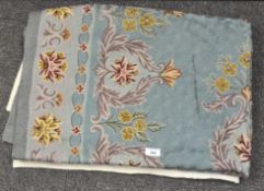 A 20th century blue ground flower patterned crewel work rug,