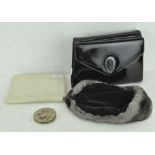 A selection of vintage items, including two patent leather handbags, a fur hat,