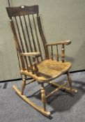 A 20th century spindle back rocking chair on turned supports,