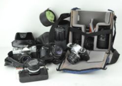 A collection of vintage camera and equipment, comprising: an Olympus OM10, assorted lenses,