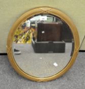 A 20th century oval wall mirror with ribbed and beaded wood frame,