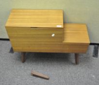 A retro sewing box seat on splayed legs,