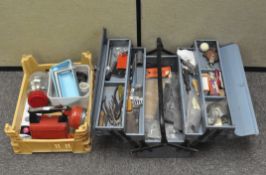 A graduated tool box containing various tools;