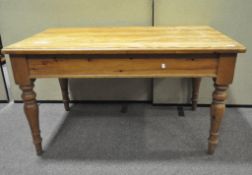 A 20th century pine kitchen table with end drawer, on turned legs,