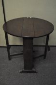 An early 20th century small oval oak gate leg side table,