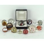 A collection of paperweights, including a boxed Caithness example, another marked Celebration,