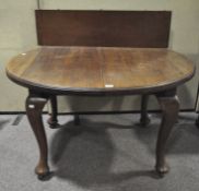 An oval mahogany dining table, on wheels, supported on four cabriole feet, with extra leaf,