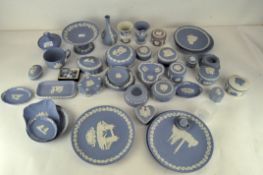A large collection of mainly 20th century Wedgwood blue jasperware including small dishes, boxes,