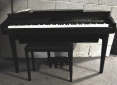 A Yamaha Clavinova digital piano and stool,