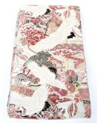 A Japanese silk obi sash, 20th century, woven with herons above buildings and landscapes,